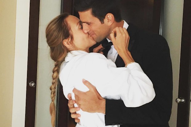 Novak and Jelena Djokovic share a kiss.