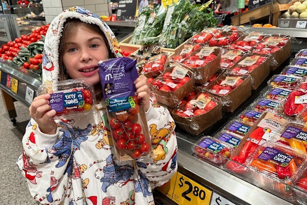Lily Waegers poses with products that donate cash to Maddie Reiwoldt's Vision.