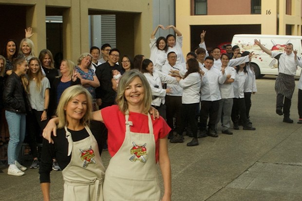 Katherine Westwood and Sophie Gilliatt pose with the staff from The Dinner Ladies.