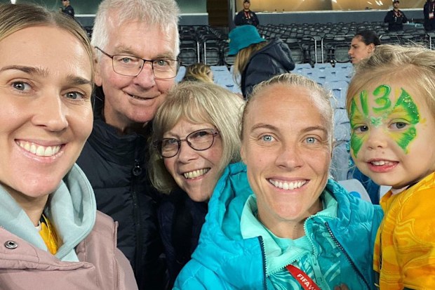 Tameka Yallop of the Matildas (second right) with her family, including daughter Harley.