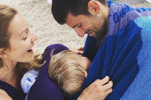 Novak and Jelena Djokovic play with their son Stefan on a beach.