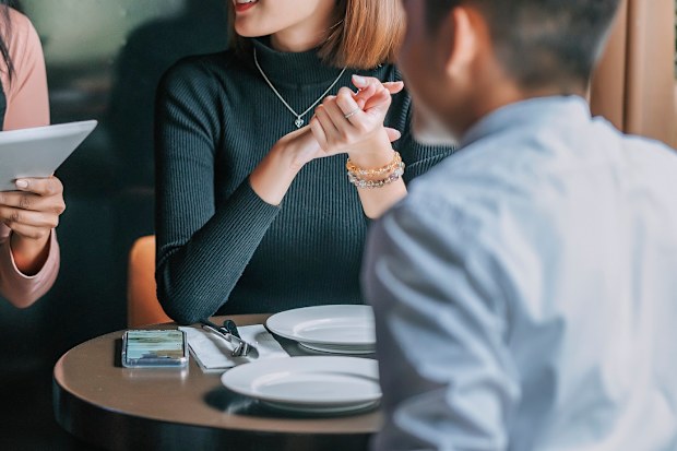 Couple ordering food at restaurant