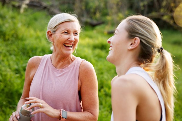 Fitness, laughing and mom with girl in nature for workout, outdoor exercise or wellness for health. Mature mother, daughter or happy women in park for training, sports routine or bonding
