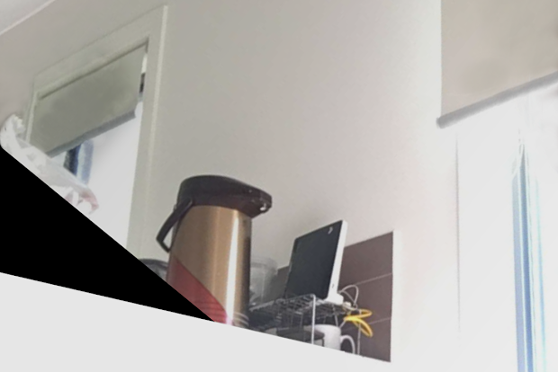 A kitchen complete with an internet modem, window blinds and coffee mugs.