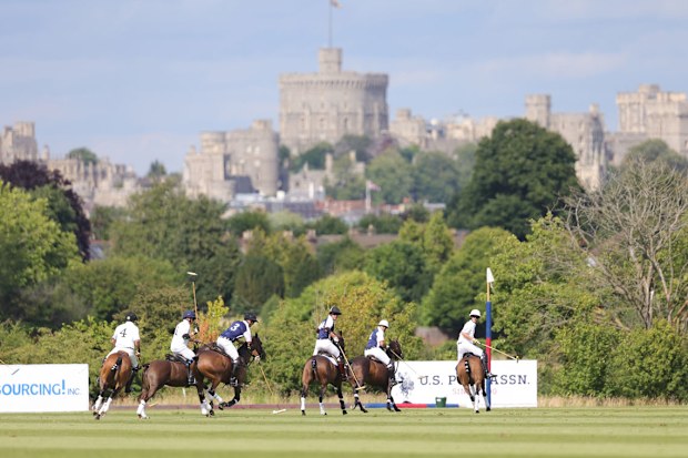 Prince William, Duke of Cambridge (C) rides during the Royal Charity Polo Cup 2022 at Guards Polo Club  during the Outsourcing Inc. Royal Polo Cup at Guards Polo Club, Flemish Farm on July 06, 2022 in Windsor, England