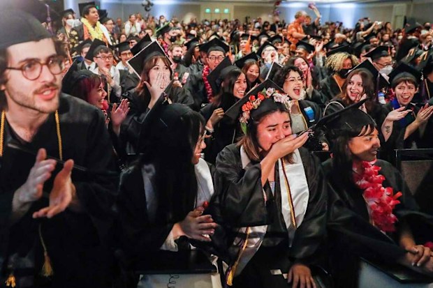 Miranda Kerr and husband Evan Spiegel surprise graduating college students by paying off all $14 million of their student loans.
