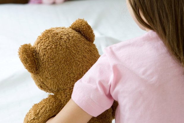 Girl holding teddy bear