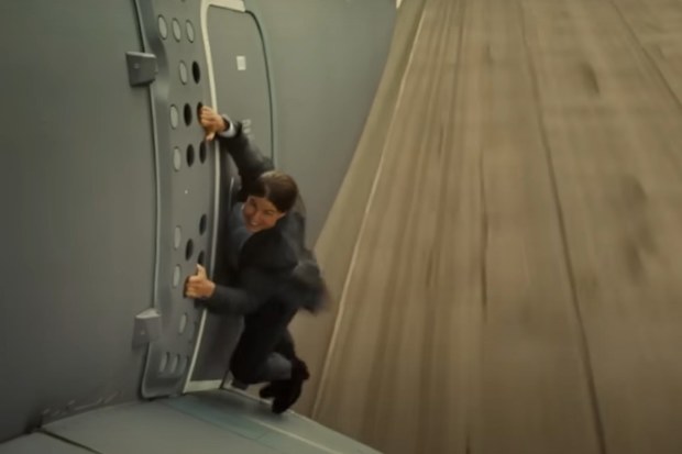 Tom Cruise hanging onto the side of a plane for a Mission: Impossible stunt