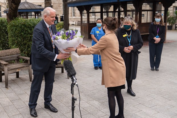 Chief Executive of St Bartholomew's Hospital Professor Charles Knight receives flowers from Queen Elizabeth II during a ceremony at St Bartholomew's Hospital, London on the anniversary of the first national lockdown to prevent the spread of coronavirus. (Photo: March 23, 2021)