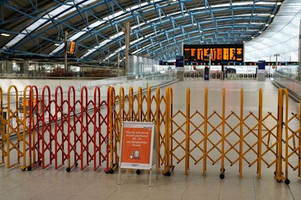 A sign states some platforms are closed during the industrial action at Waterloo railway station in London, Tuesday, June 21, 2022.