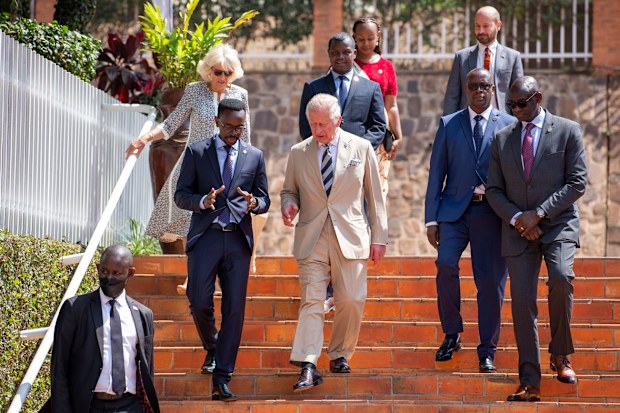 Prince Charles, center, and Camilla, Duchess of Cornwall, above-left, arrive to visit the Kigali Genocide Memorial in the capital Kigali, Rwanda Wednesday, June 22, 2022.