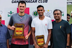 Bernard Tomic poses with his trophy after taking out the ITF M25 Chennai tournament.
