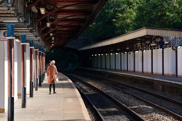 A passenger waits at Great Malvern train station as members of the Rail, Maritime and Transport union begin their nationwide strike, in Worcester, England, Tuesday June 21, 2022. 