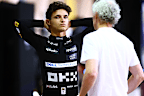 Lando Norris speaks to his manager during pre-season testing.