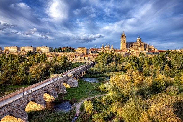 Aerial view of Salamanca with the cathedral in the background and the roman bridge in the foreground.