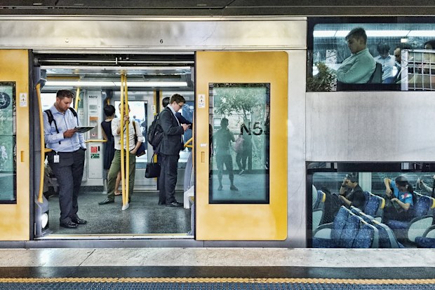 Sydney, NSW, Australia - March 12, 2015. People standing and sitting on the Cityrail train in Sydney. Trains in Sydney have two levels for seating.