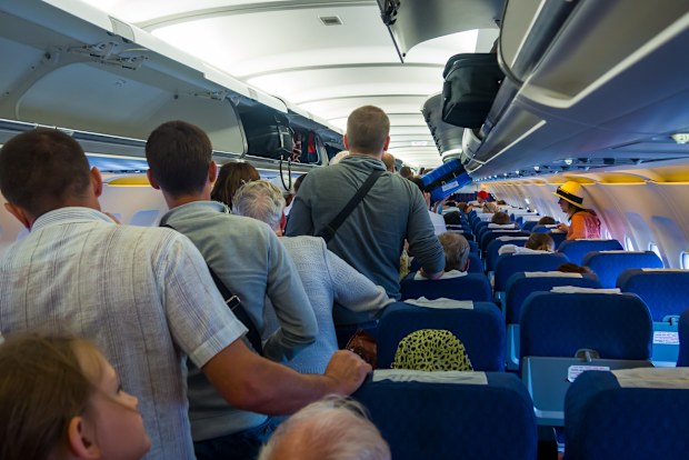 passengers standing on a plane