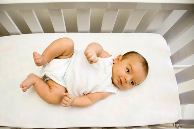 Newborn in cot