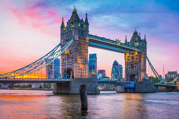 Pretty pink hues light up the sky at dusk at London Bridge. iStock