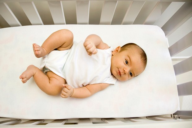 Newborn in cot