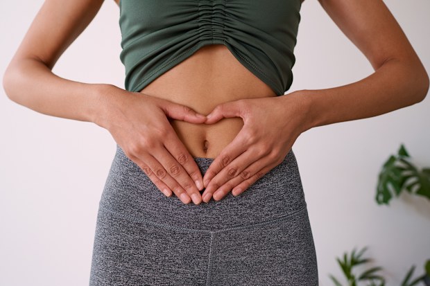 Close up of a woman's hands on her stomach. High quality photo