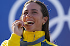Noemie Fox of Australia poses with the gold medal in the women's kayak cross finals during the canoe slalom at the 2024 Summer Olympics, Monday, Aug. 5, 2024, in Vaires-sur-Marne, France. (AP Photo/Kirsty Wigglesworth)