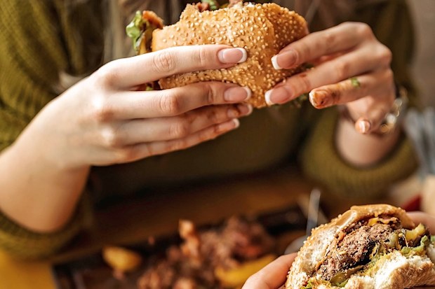 woman eating hamburger