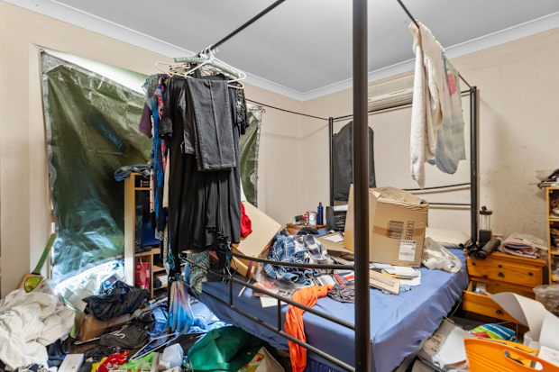 Clothes and other personal items strewn across the floor of the Queensland house.