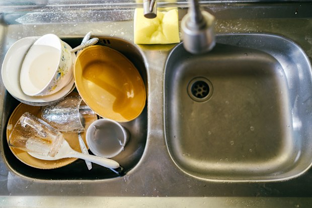 Dirty dishes in the house kitchen sink in evening