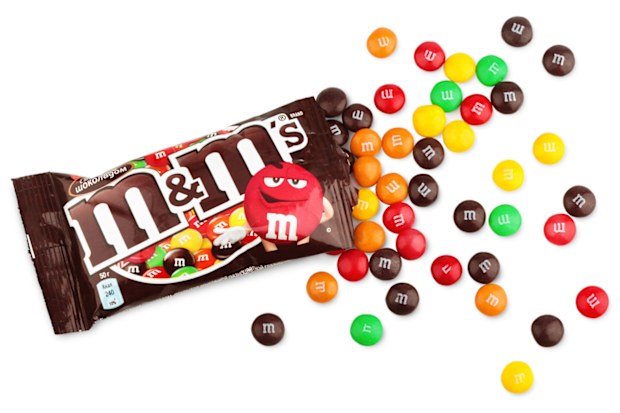 Closeup of unwrapped M&M's milk chocolate candies made by Mars Inc.