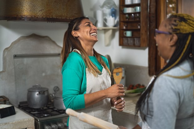 Women cooking in the kitchen. Female friends. Friends cooking. 