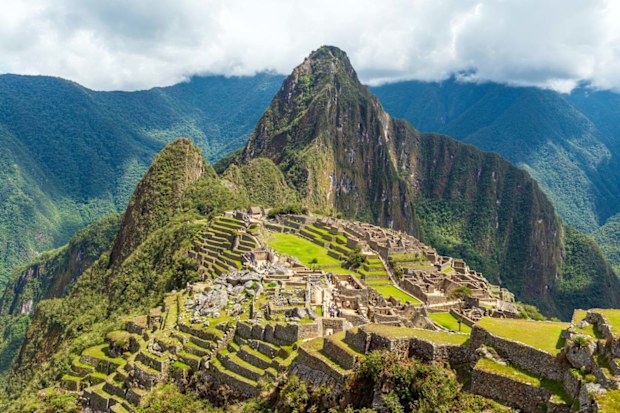 Machu Picchu inca ruins with dramatic clouds, Cusco, Peru.