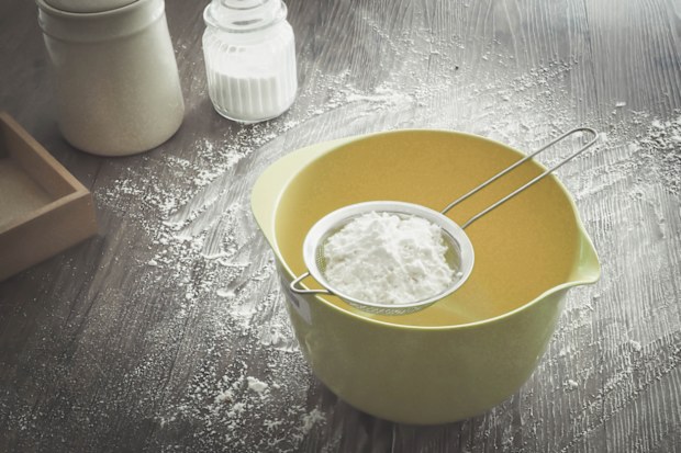 cornstarch in a sieve over a bowl