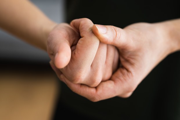 Person cracking knuckles.