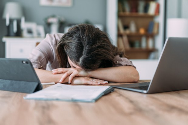 Shot of businesswoman sleeping on his desk while working from home.