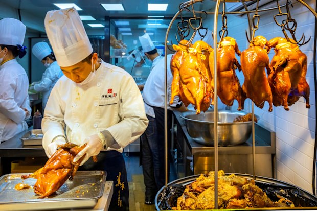 Beijing, China - Jan 14 2020: Unidentified people in a restaurant at Nanluoguxiang, a combination of traditional Beijing Hutong and refurbished pedestrian street