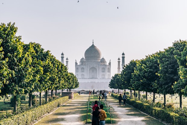 The Taj Mahal seen at sunset from the Mehtab Bagh. It lies north of the Taj Mahal complex on the opposite side of the Yamuna River. The garden complex is perfectly aligned with the Taj Mahal on the opposite bank