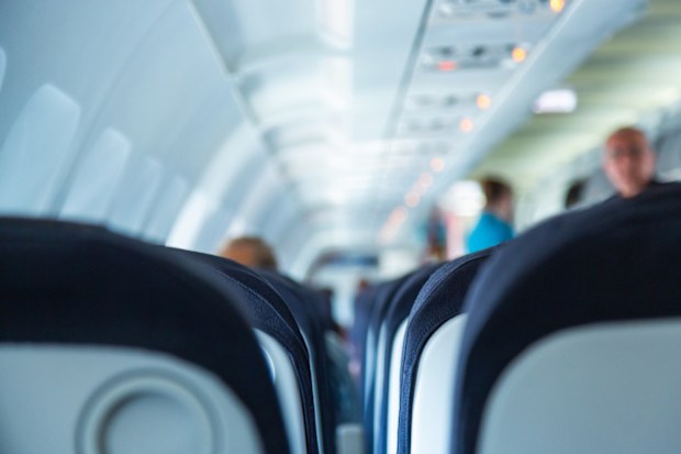 Airplane cabin during boarding. Shallow DOF, selective focus.