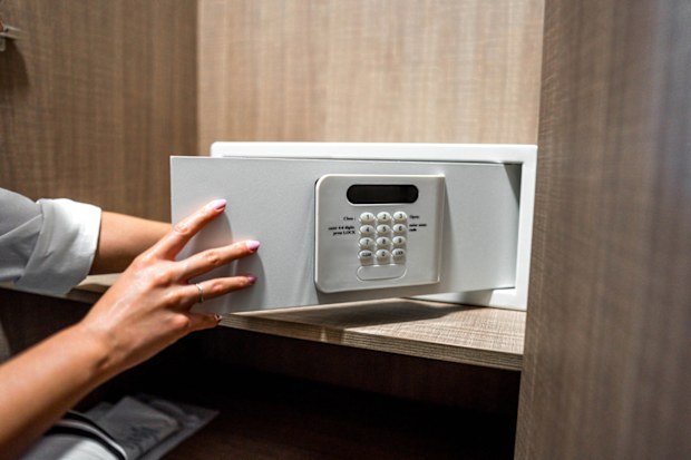 Woman using a safe box in a hotel room