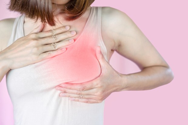 Asian woman checking her breast, self cancer examination concept