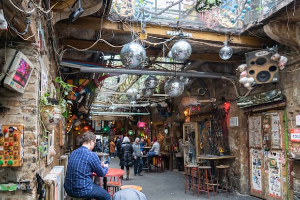 Budapest, Hungary - February 2020: Szimpla Garden ruin bar / pub with visitors - a popular spot for locals and tourists in Budapest