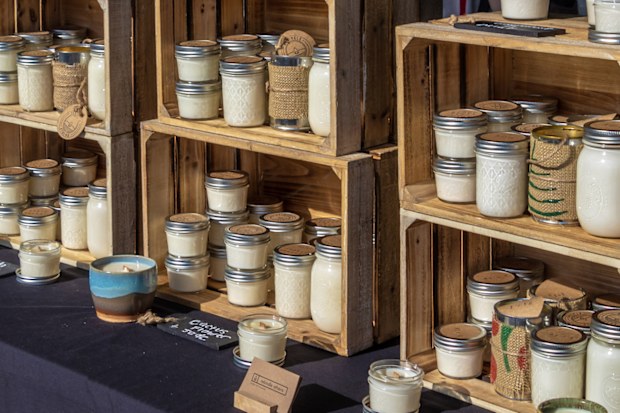 Athens, GA  June 15, 2019: A display of soy wax candles offered as a sustainable alternative to paraffin at the Athens Farmers Market.