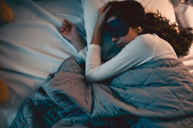 Female Getting Good Rest With The Help Of Sleeping Mask And Ear Plugs