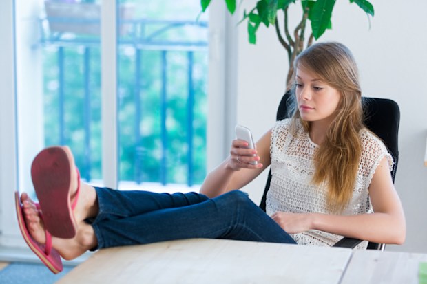 Woman wearing thongs in the office istock