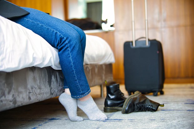 Tired female business travel checked into a hotel room