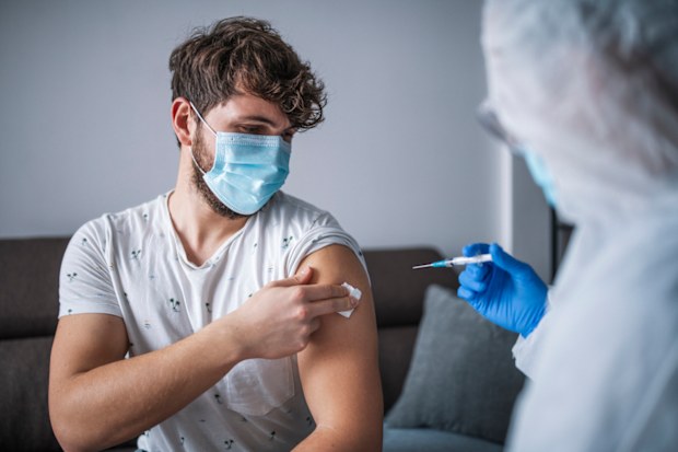 Man getting vaccinated. Vaccine. Needle
