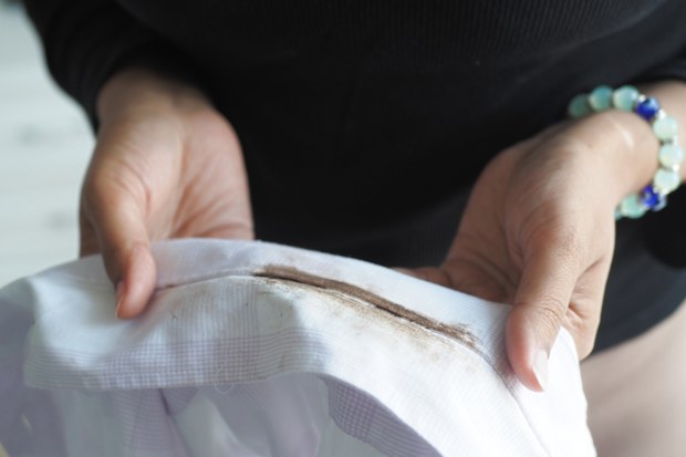 woman holding stained white shirt