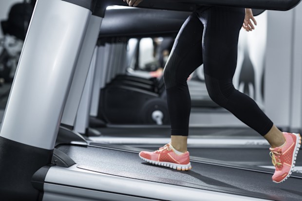Detail from treadmill in the gym. Selective focus on human les.