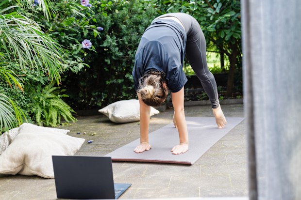 Caucasian fit woman doing yoga workout outdoors.