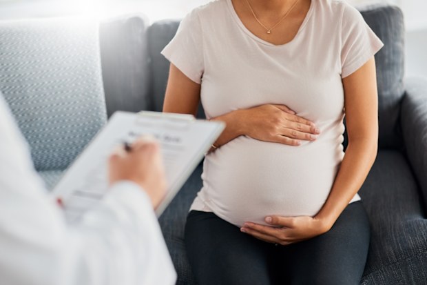 Shot of a pregnant young woman at the doctor